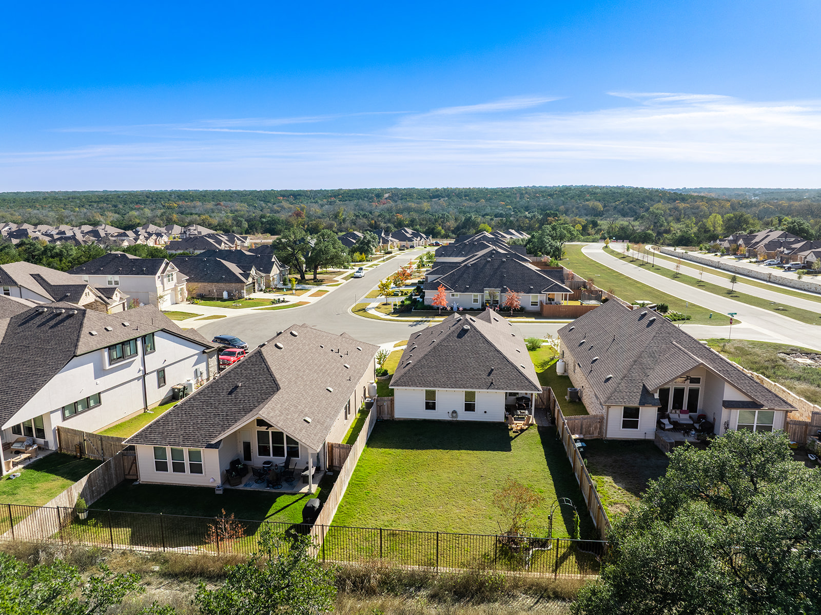 Aerial view of Water Oak at San Gabriel — homes backing to greenbelt and San Gabriel River trees