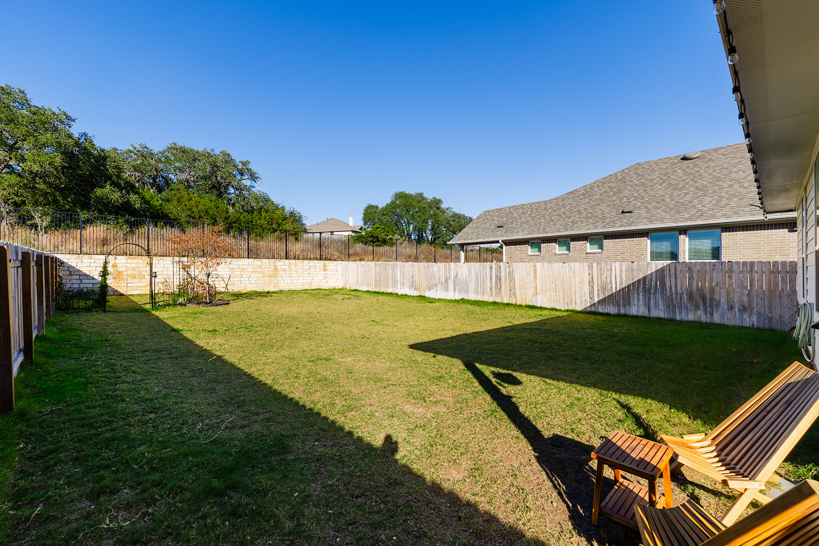 Backyard with greenbelt views — large fenced yard backing to park with mature trees and no rear neighbors