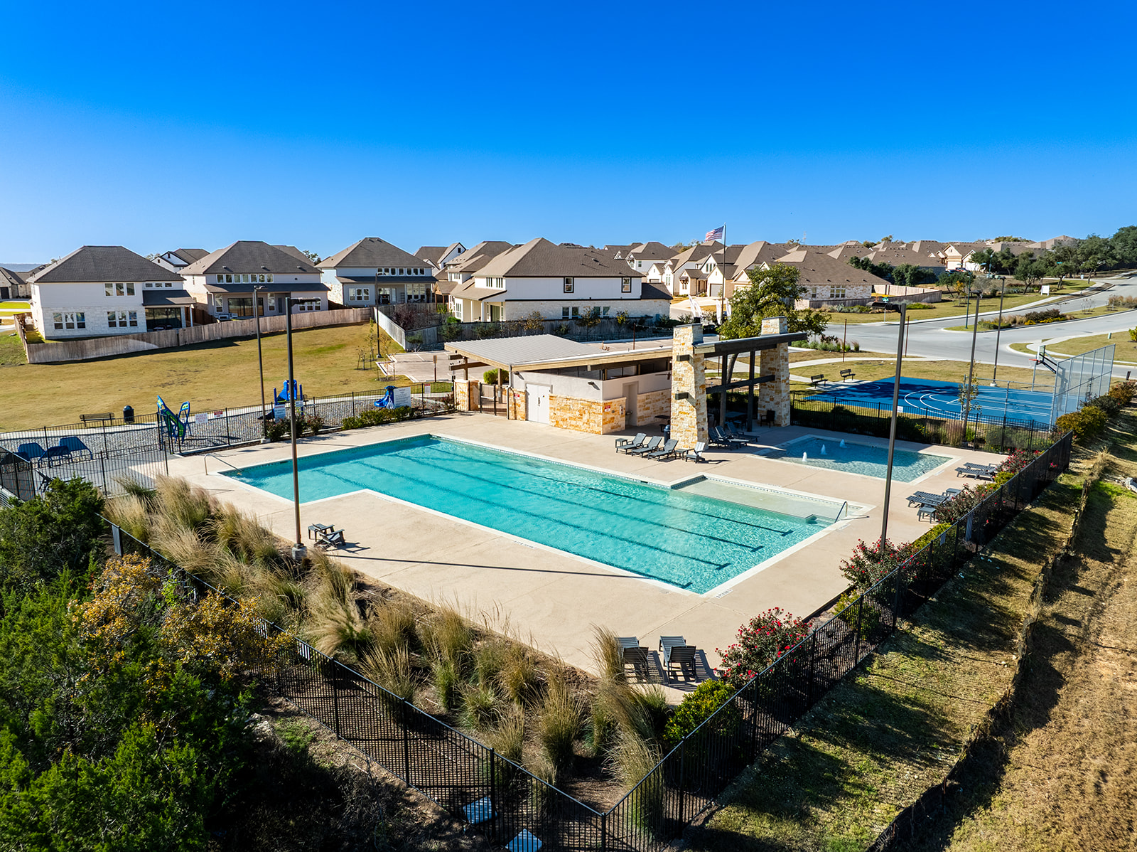Aerial view of community pool, pavilion, basketball court and green space at Water Oak